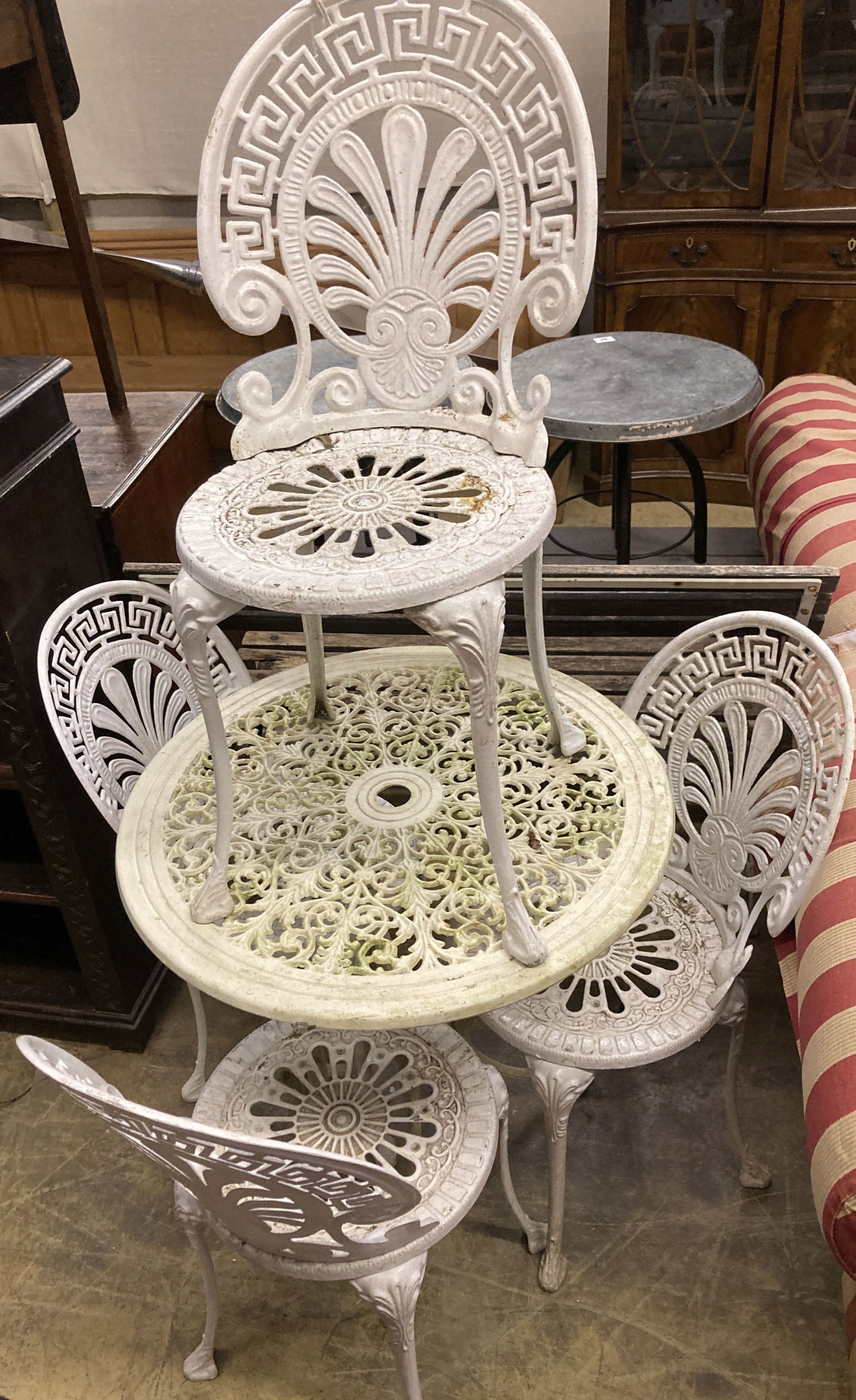 A circular Victorian style painted aluminium garden table, diameter 69cm together with a set of four similar chairs